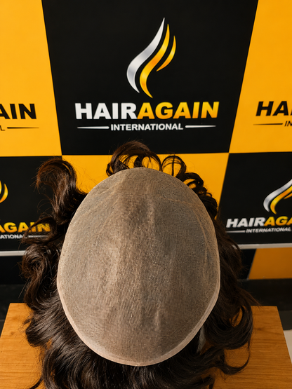 HairAgain International product display with a head model wearing a hairpiece against a branded backdrop.